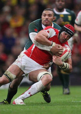 13.11.10 .. Wales v South Africa. -  Wales' Jonathan Thomas is held by South Africa's Bjorn Basson   