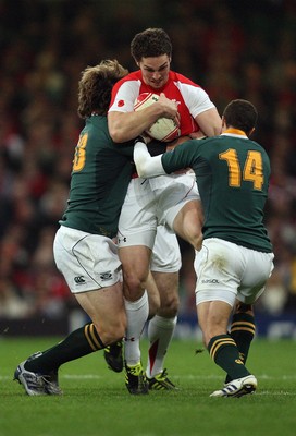 13.11.10 .. Wales v South Africa. -  Wales' George North is tackled by South Africa's Francois Steyn and Bjorn Basson  