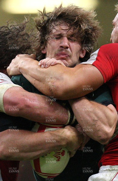 13.11.10 .. Wales v South Africa. -  South Africa's Francois Steyn is stopped by Wales' Andy Powell and Adam Jones  