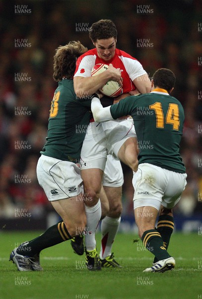 13.11.10 .. Wales v South Africa. -  Wales' George North is tackled by South Africa's Francois Steyn and Bjorn Basson  