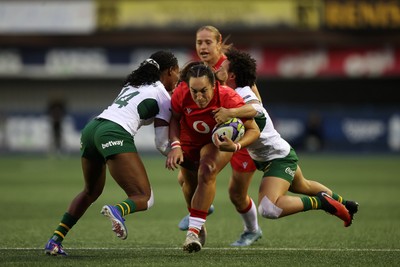 180926 - Wales Women v South Africa Women - Vodafone Wales WXV Series - Courtney Keight of Wales is tackled by Maria Tshiremba of South Africa 