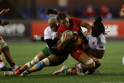 180926 - Wales Women v South Africa Women - Vodafone Wales WXV Series - Branwen Metcalfe of Wales is tackled by Aphiwe Ngwevu of South Africa 