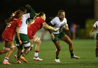 180926 - Wales Women v South Africa Women - Vodafone Wales WXV Series - Libbie Janse Van Rensburg of South Africa is tackled by Gwen Crabb of Wales 
