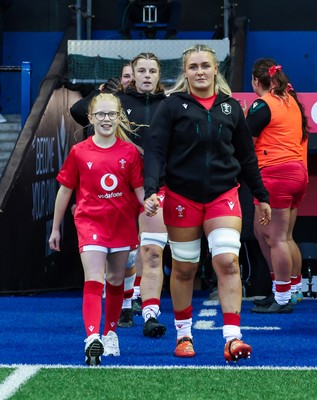 190926 Wales v South Africa, Vodafone Wales WXV Series - Wales co-captain Alex Callender walks out with match mascot Lola Snowdon