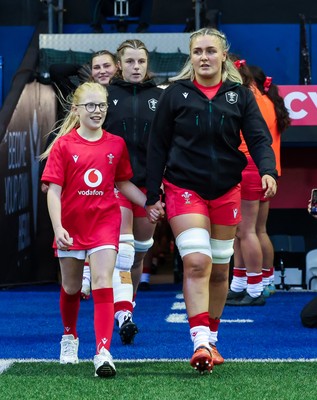 190926 Wales v South Africa, Vodafone Wales WXV Series - Wales co-captain Alex Callender walks out with match mascot Lola Snowdon