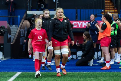 190926 Wales v South Africa, Vodafone Wales WXV Series - Wales co-captain Alex Callender walks out with match mascot Lola Snowdon