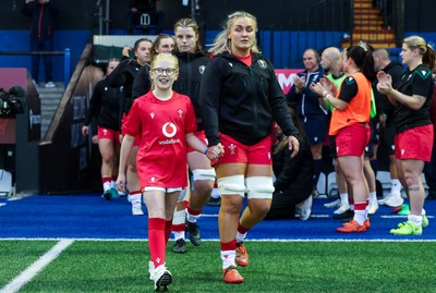 190926 Wales v South Africa, Vodafone Wales WXV Series - Wales co-captain Alex Callender walks out with match mascot Lola Snowdon