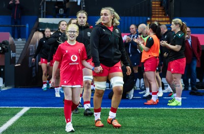190926 Wales v South Africa, Vodafone Wales WXV Series - Wales co-captain Alex Callender walks out with match mascot Lola Snowdon