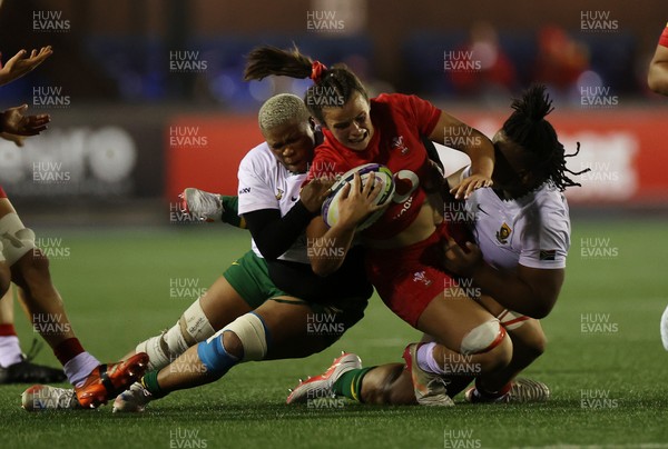 180926 - Wales Women v South Africa Women - Vodafone Wales WXV Series - Branwen Metcalfe of Wales is tackled by Aphiwe Ngwevu of South Africa 