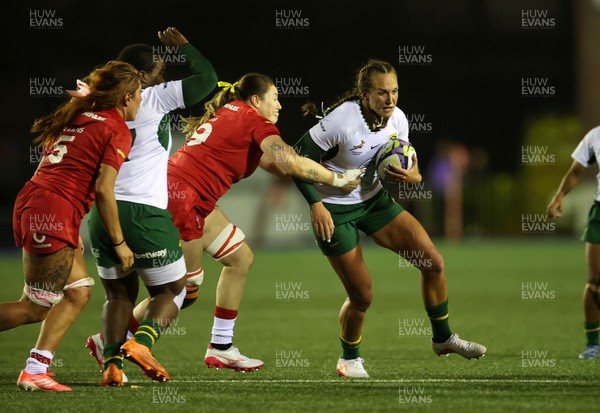180926 - Wales Women v South Africa Women - Vodafone Wales WXV Series - Libbie Janse Van Rensburg of South Africa is tackled by Gwen Crabb of Wales 