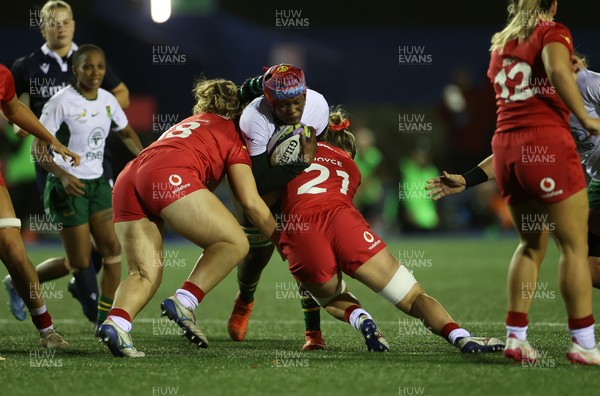 180926 - Wales Women v South Africa Women - Vodafone Wales WXV Series - Sinelitha Noxeke of South Africa is tackled by Elan Jones of Wales 