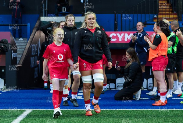 190926 Wales v South Africa, Vodafone Wales WXV Series - Wales co-captain Alex Callender walks out with match mascot Lola Snowdon