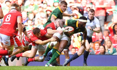 190823 - Wales v South Africa - Vodaphone Summer Series - Siya Kolisi of South Africais tackled by Tom Rogers of Wales