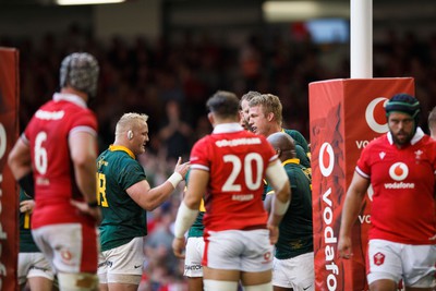 190823 - Wales v South Africa - Summer Series - Pieter-Steph du Toit of South Africa is congratulated after scoring a try as Wales look dejected