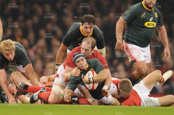 241118 - Wales v South Africa - Under Armour Series -  Cheslin Kolbe of South Africa is tackled by Alun Wyn Jones of Wales 