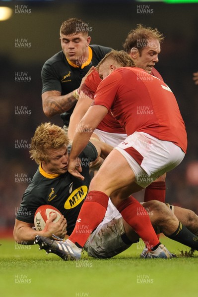 241118 - Wales v South Africa - Under Armour Series - Pieter-Steph du Toit of South Africa is tackled by Tomas Francis of Wales and Alun Wyn Jones of Wales 