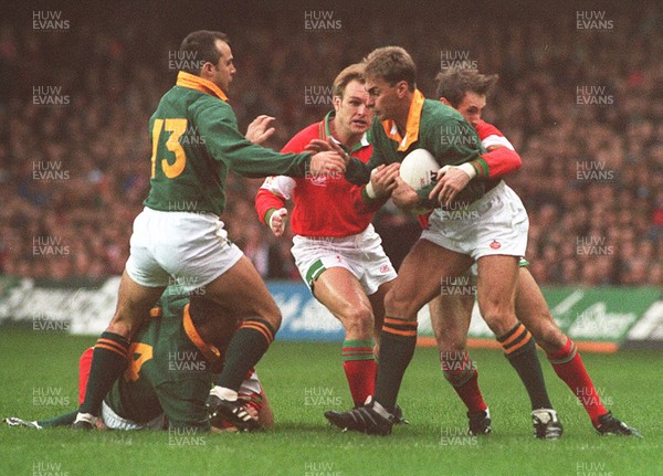 261194 - Wales v South Africa - Andre Joubert of South Africa is tackled by Wayne Proctor and Mike Hall as Pieter Muller (L) watches 