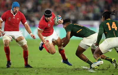 271019 - Wales v South Africa - Rugby World Cup Semi-Final - Leigh Halfpenny of Wales is tackled by Lukhanyo Am of South Africa