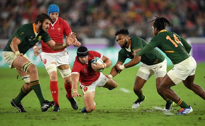 271019 - Wales v South Africa - Rugby World Cup Semi-Final - Leigh Halfpenny of Wales is tackled by Lukhanyo Am of South Africa