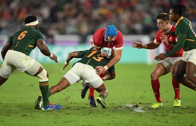 271019 - Wales v South Africa - Rugby World Cup Semi-Final - Justin Tipuric of Wales is tackled by Lukhanyo Am of South Africa