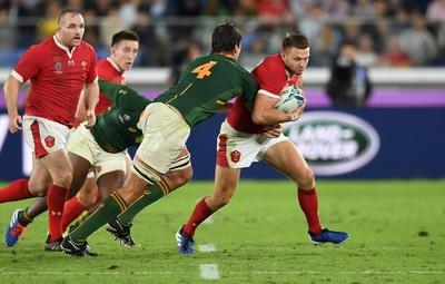 271019 - Wales v South Africa - Rugby World Cup Semi-Final - Dan Biggar of Wales is tackled by Eben Etzebeth of South Africa