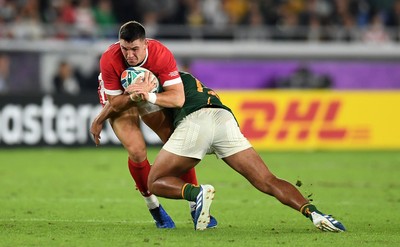 271019 - Wales v South Africa - Rugby World Cup Semi-Final - Owen Watkin of Wales is tackled by Damian de Allende of South Africa