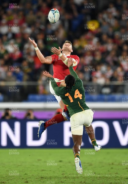 271019 - Wales v South Africa - Rugby World Cup Semi-Final - Dan Biggar of Wales gets to the high ball before Sbu Nkosi of South Africa