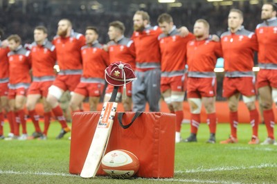 291114 - Wales v South Africa - Dove Men Series -A cricket bat is propped up with a WRU cap on it in remembrance of Australian cricketer Phil Hughes at the Millennium Stadium