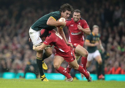 291114 - Wales v South Africa - Dove Men Series - Eben Etzebeth of South Africa is taken down by Leigh Halfpenny of Wales