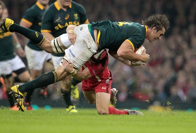 291114 - Wales v South Africa - Dove Men Series - Eben Etzebeth of South Africa is taken down by Leigh Halfpenny of Wales