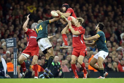 291114 - Wales v South Africa, Dove Men Series 2014, Cardiff - Leigh Halfpenny of Wales wins the ball as Cornal Hendricks of South Africa challenges