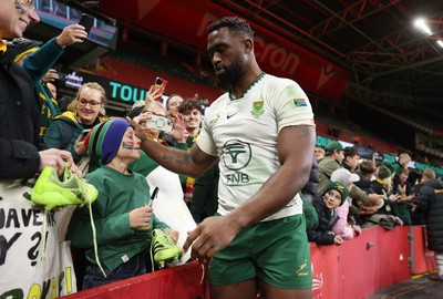 291125 - Wales v South Africa Springboks - Quilter Nations Series - Taine Plumtree of Wales gives his boots to a young fan