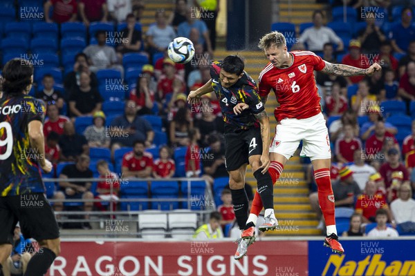 070923 - Wales v South Korea - International Friendly - Joe Rodon of Wales wins a header over Minjae Lee of South Korea