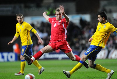 030310 - International Football Friendly, Wales v SwedenWales' Jack Collison and Sweden's Behrang Safari compete, Sweden's Kim Kallstrom looks on