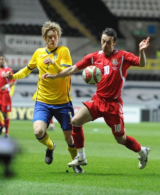 03.03.10 - International Football Friendly, Wales v Sweden Wales' Simon Davies is challenged by Sweden's Rasmus Elm 