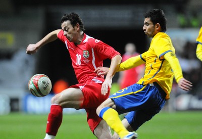 03.03.10 - International Football Friendly, Wales v Sweden Wales' Simon Davies is challenged by Sweden's Behrang Safari 