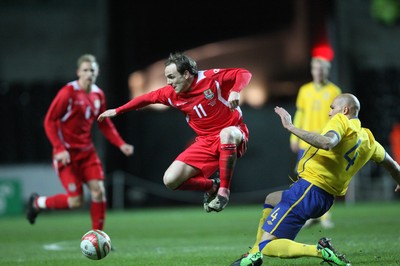 03.03.10 ... Wales v Sweden, Friendly International, Swansea -  Wales' David Vaughan is tackled by Sweden's Daniel Majstorovic  