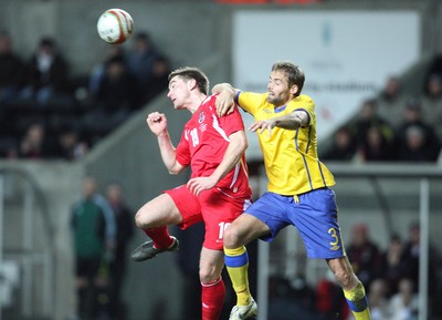 03.03.10 ... Wales v Sweden, Friendly International, Swansea -  Wales' Sam Vokes and Sweden's Olof Mellberg compete for the ball 