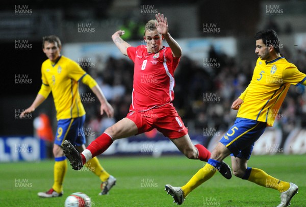 030310 - International Football Friendly, Wales v SwedenWales' Jack Collison and Sweden's Behrang Safari compete, Sweden's Kim Kallstrom looks on
