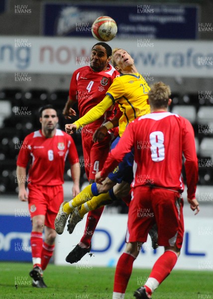 03.03.10 - International Football Friendly, Wales v Sweden Wales' Ashley Williams and Sweden's Christian Wilhelm go for a high ball 