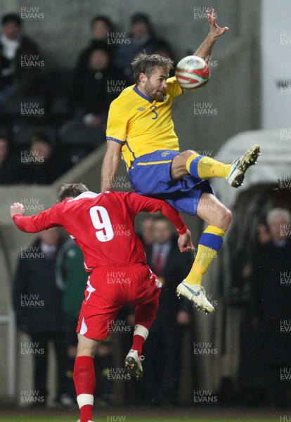 03.03.10 ... Wales v Sweden, Friendly International, Swansea -  Sweden's Olof Mellberg is challenged by Wales' Simon Church   