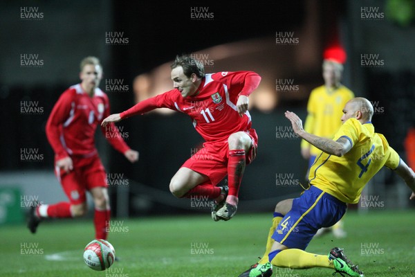 03.03.10 ... Wales v Sweden, Friendly International, Swansea -  Wales' David Vaughan is tackled by Sweden's Daniel Majstorovic  