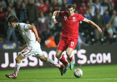 07.10.11 -  Wales v Switzerland, Euro 2012 Qualifying Match -  Wales' Gareth Bale takes on Switzerland's Timm Klose  