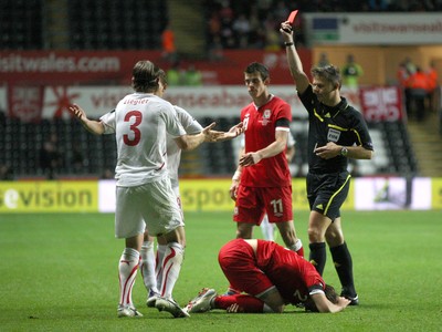 07.10.11 -  Wales v Switzerland, Euro 2012 Qualifying Match -  Switzerland's Reto Ziegler is shown red card for his challenge on Wales' Chris Gunter   