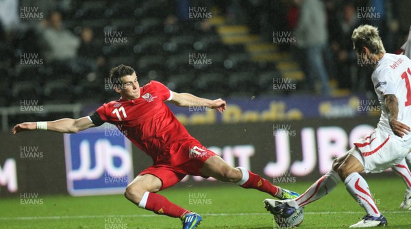 07.10.11 -  Wales v Switzerland, Euro 2012 Qualifying Match -  Wales' Gareth Bale takes on Switzerland's Valon Behrami  