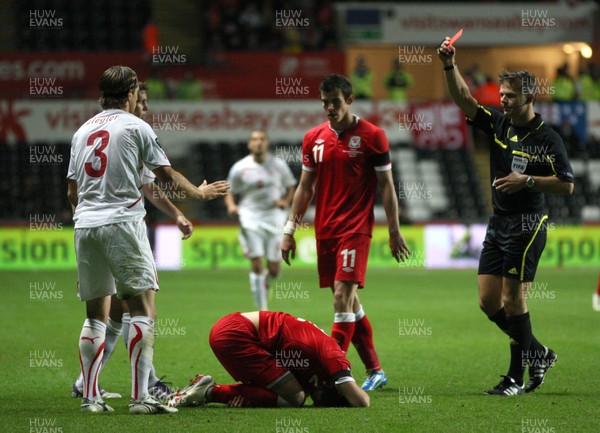 07.10.11 -  Wales v Switzerland, Euro 2012 Qualifying Match -  Switzerland's Reto Ziegler is shown red card for his challenge on Wales' Chris Gunter   
