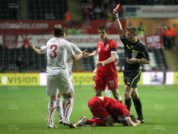 07.10.11 -  Wales v Switzerland, Euro 2012 Qualifying Match -  Switzerland's Reto Ziegler is shown red card for his challenge on Wales' Chris Gunter   