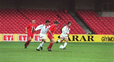 141296 - Wales v Turkey - Vinnie Jones (left) and Mark Hughes of Wales in action at Cardiff Arms Park in front of a small crowd