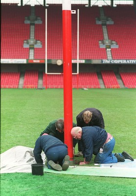 141296 - Wales v Turkey - Ground staff put rugby posts back into position following the conclusion of the match ready for Wales v South Africa the next day
