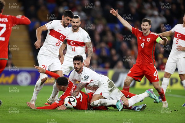 211123 - Wales v Turkey - UEFA Euro 2024 Qualifier - Brennan Johnson of Wales is flattened by Samet Akayd�n of Turkey 